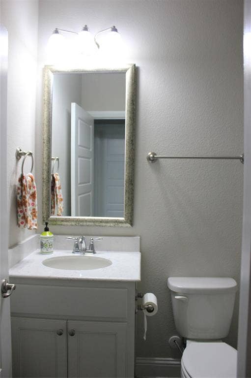 940 Parkside Drive, Argyle, TX 76226 2nd bath with White vanity with dual cabinet doors, integrated sink, chrome faucet, and coordinating hardware