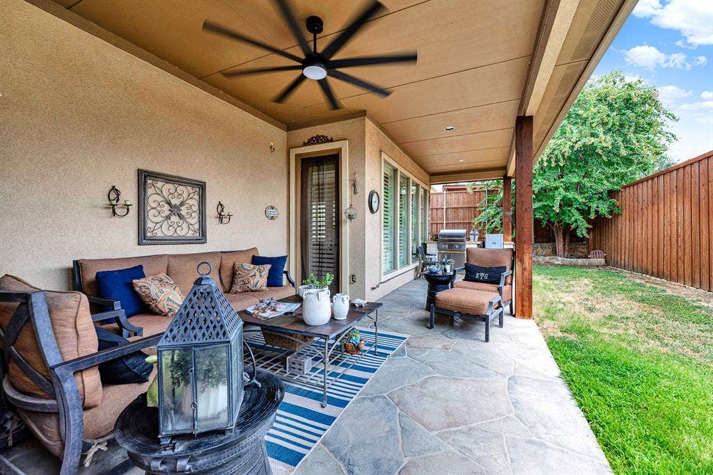 7032 PORTOBELLO Drive, Plano, TX 75024 Recessed lighting and a sleek, oversized ceiling fan enhance the spacious overhang, keeping midday breezes circulating over the stamped concrete floor. Kick back with a good book on a quiet afternoon while staying sheltered from the summer sun.