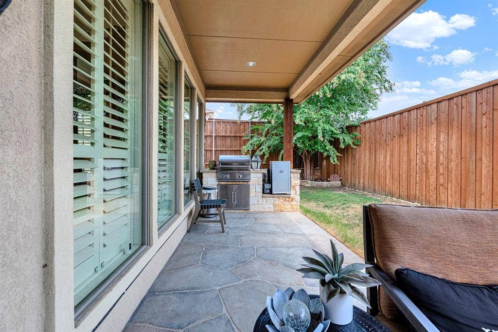 7032 PORTOBELLO Drive, Plano, TX 75024 A custom stone island seamlessly integrates a built-in gas grill and electric smoker under the protective roofline. Savor slow-smoked barbecue on game days, enjoying effortless outdoor cooking steps from your back door.