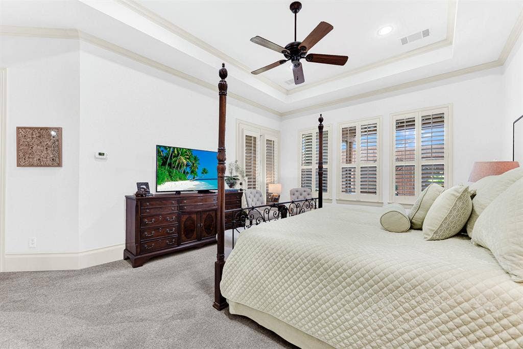 7032 PORTOBELLO Drive, Plano, TX 75024 Deep crown moldings highlight the room's generous proportions and seamless connection to private outdoor access. Start your mornings feeling completely restored in a spacious, sun-dappled haven