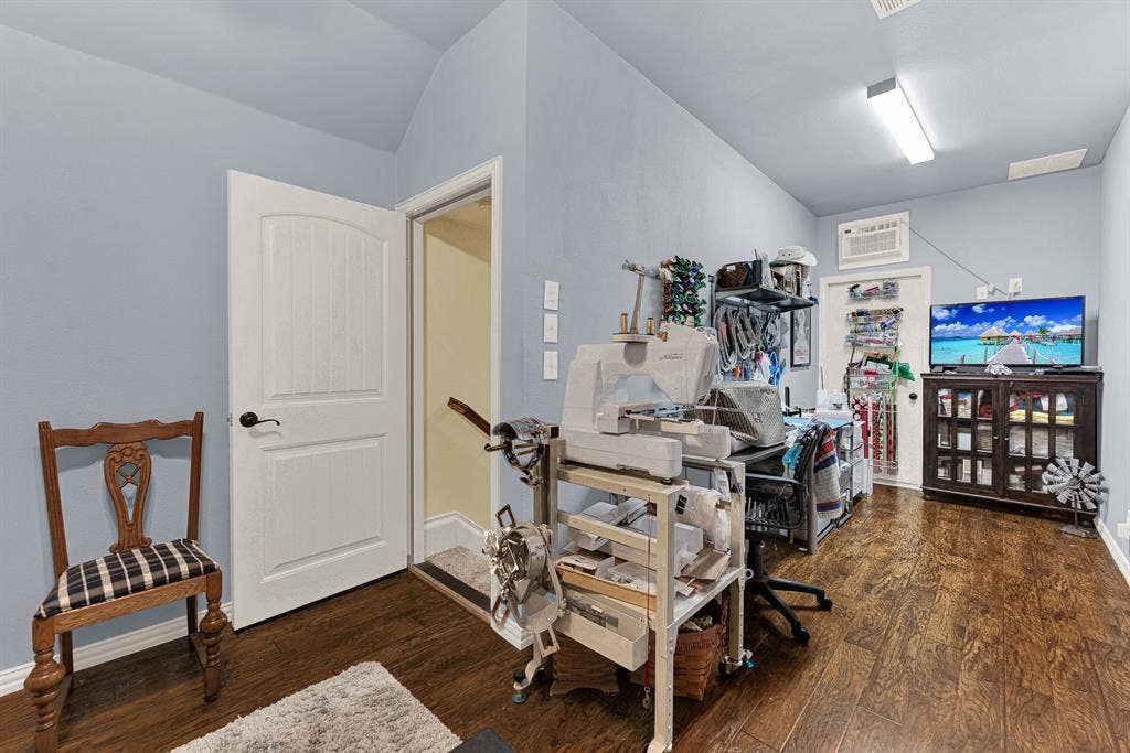 7032 PORTOBELLO Drive, Plano, TX 75024 Angled ceilings lead up from the private stairwell into a bright second-floor flex space grounded by warm wooden flooring. Set up a dedicated hobby studio where creativity flows uninterrupted all afternoon.