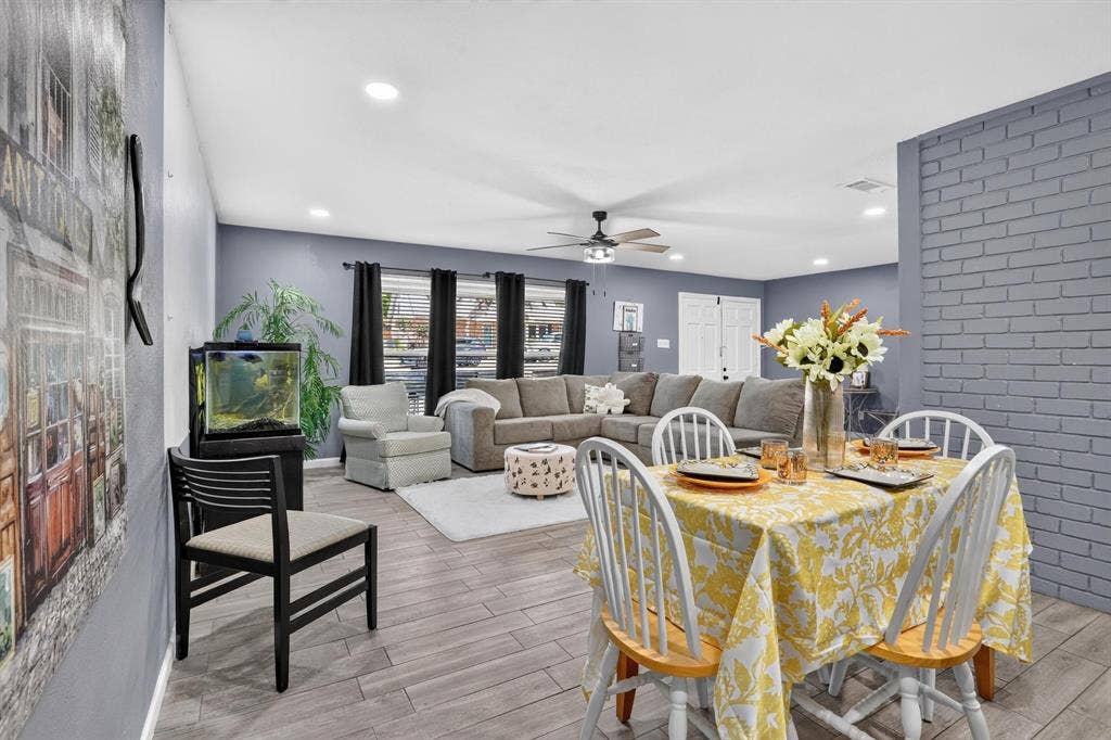 8117 Rush Street, Benbrook, TX 76116 Open-concept living and dining area featuring wood-finish flooring, recessed ceiling lighting, and a ceiling fan