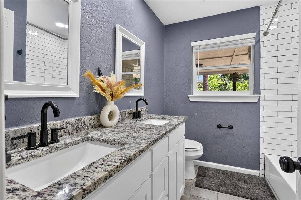 8117 Rush Street, Benbrook, TX 76116 Double vanity with granite countertop, undermount sinks, and matte black fixtures