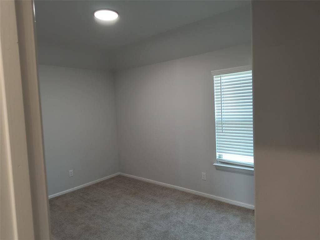 320 Leopold Trail, Greenville, TX 75402 Recessed ceiling light, neutral wall paint, window with blinds, and carpeting
