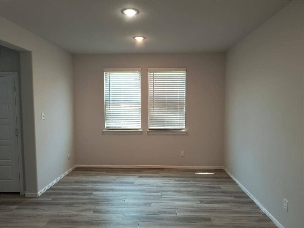 320 Leopold Trail, Greenville, TX 75402 Recessed lighting, wood-finish flooring, and two windows with blinds