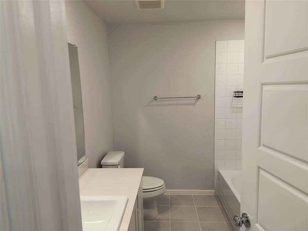 320 Leopold Trail, Greenville, TX 75402 Vanity with a white countertop and integrated sink, chrome faucet, and rectangular mirror