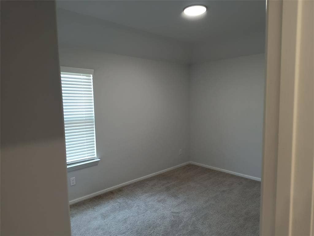 320 Leopold Trail, Greenville, TX 75402 Carpeted flooring, recessed ceiling lighting, and window with horizontal blinds