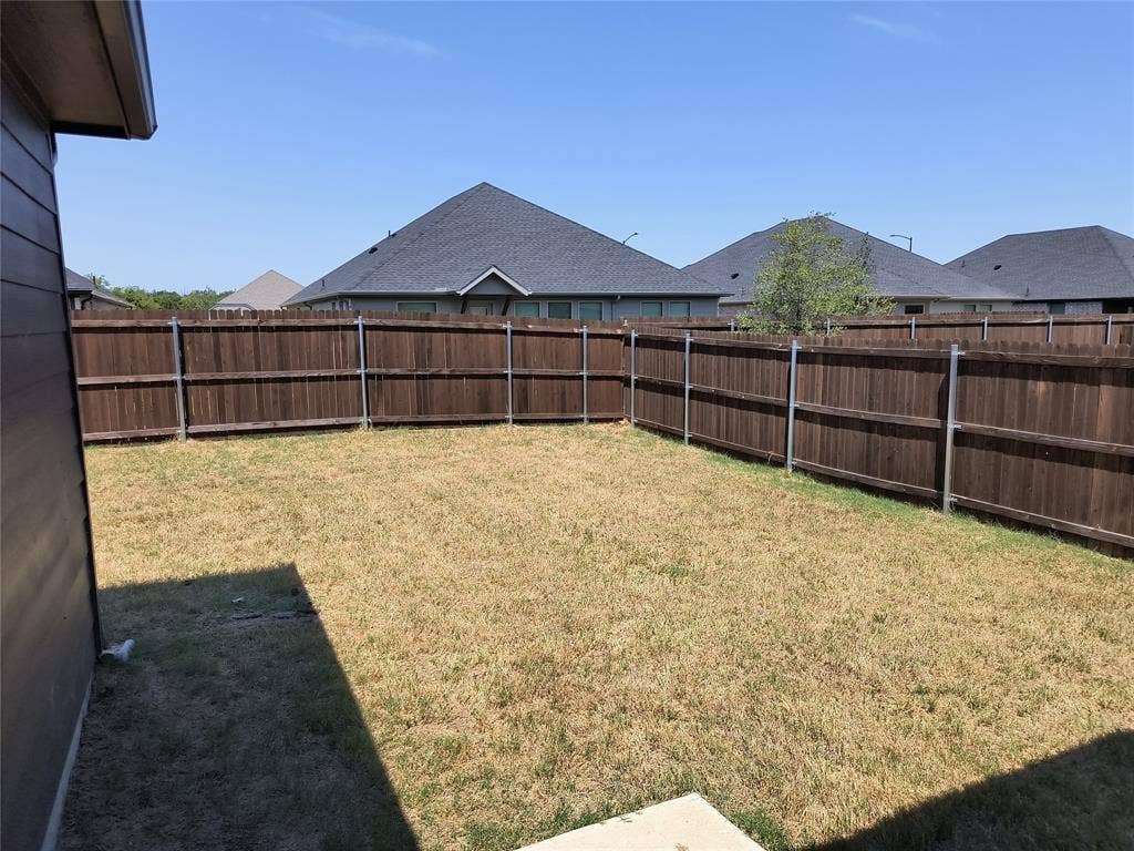 320 Leopold Trail, Greenville, TX 75402 Fenced yard with wood fencing and metal posts