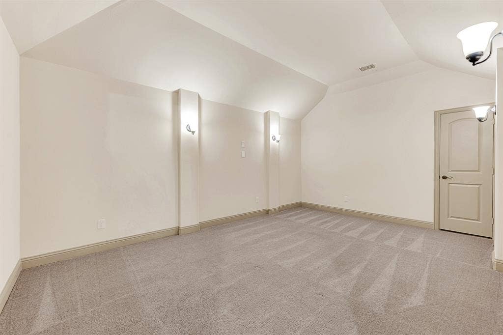 7013 BROOK FOREST Circle, Plano, TX 75024 Vertical architectural pilasters topped with soft sconce lighting frame a deep acoustic niche beneath gentle ceiling angles. Picture hosting memorable movie marathons or cheering on your favorite sports team from comfy theater recliners.