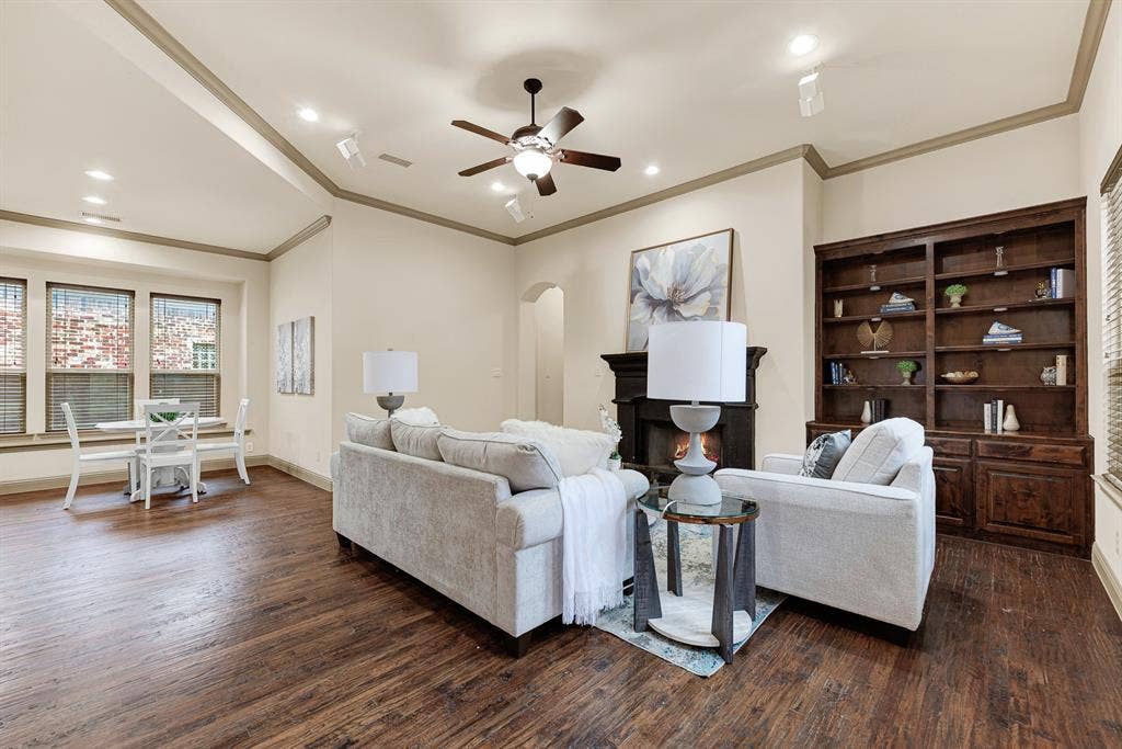 7013 BROOK FOREST Circle, Plano, TX 75024 A grand dark hearth and tailored custom bookcase anchor the tall, coved ceiling with timeless character. Unwind here after a long day, curling up by the crackling fire with a favorite novel in hand.