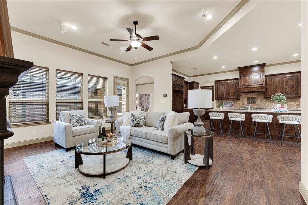 7013 BROOK FOREST Circle, Plano, TX 75024 The open plan flows into the kitchen, illuminated by recessed fixtures that define distinct living zones. It sets the scene for casual wine tastings and appetizers with friends as dinner finishes on the stove