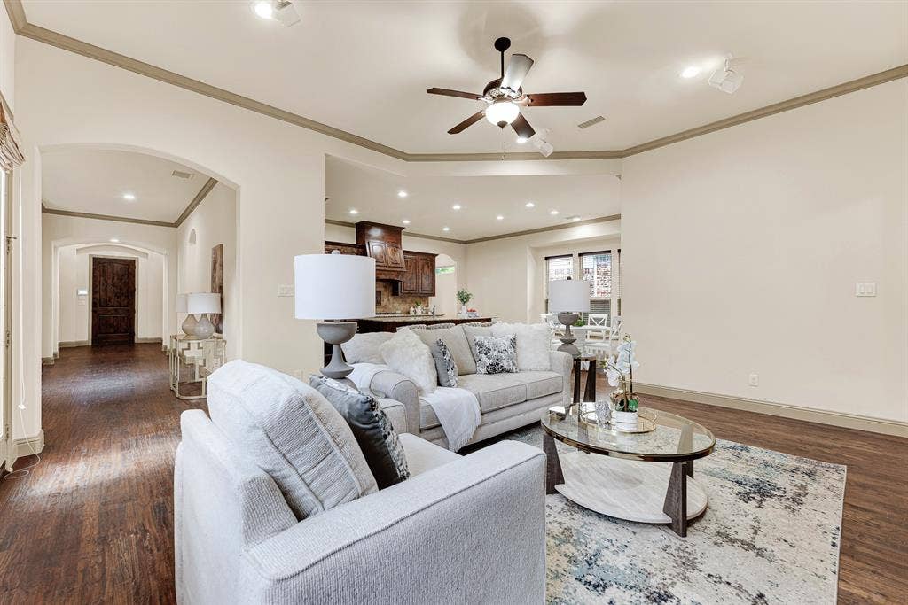 7013 BROOK FOREST Circle, Plano, TX 75024 Sweeping sightlines through the wide hall provide an effortless transition across the entire main level. Imagine hosting game nights where everyone stays connected, from the sofa lounge all the way to the breakfast bar.