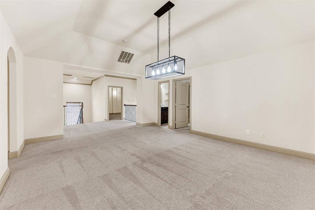 7013 BROOK FOREST Circle, Plano, TX 75024 A black open-cage chandelier anchors the expansive upper landing, seamlessly framing open sights toward the wrought-iron staircase balustrade. Envision casual family gatherings drifting easily between floors during lively weekend parties.