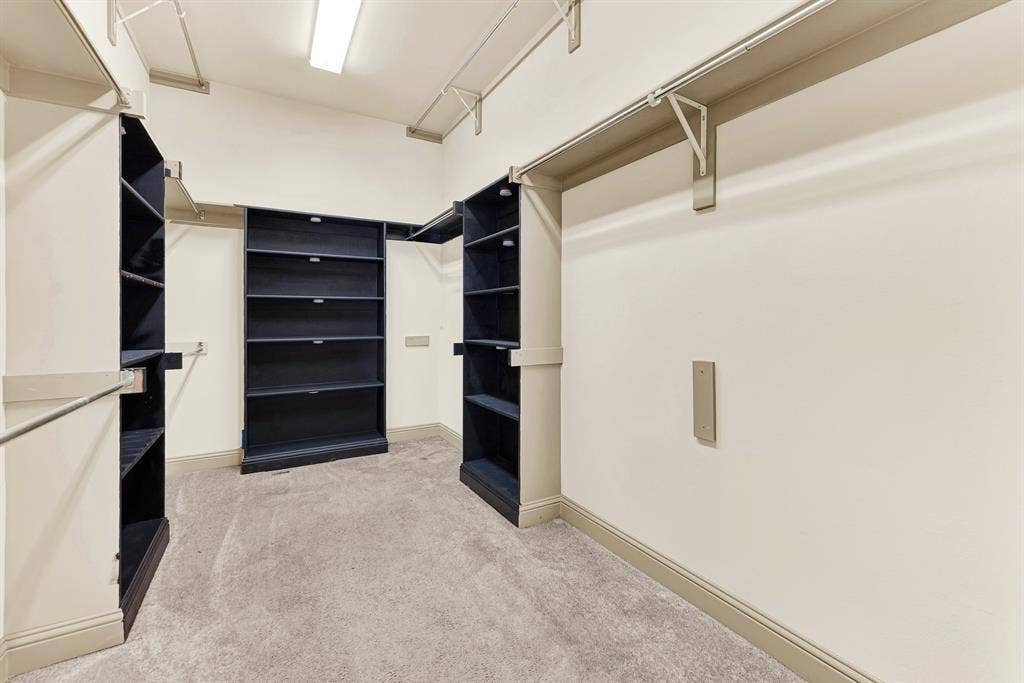 7013 BROOK FOREST Circle, Plano, TX 75024 Floor-to-ceiling shelving towers and wrap-around tiered hanging rods maximize vertical storage under clean overhead lighting. Envision easily coordinating seasonal wardrobes and selecting attire for work or formal gatherings with everything in plain view.