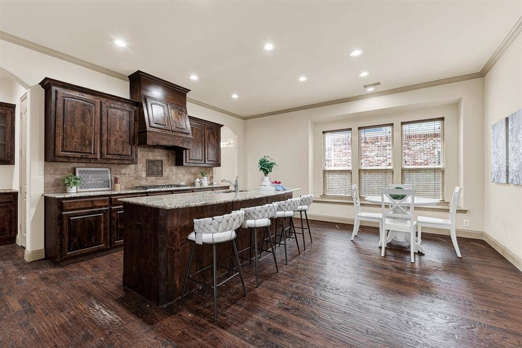 7013 BROOK FOREST Circle, Plano, TX 75024 The wide central passageway creates seamless circulation, uniting the specialized serving area with the casual dining space. It makes entertaining effortlessly fluid, whether replenishing party platters from the pantry or chatting with family across the room.