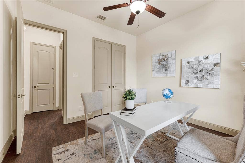 7013 BROOK FOREST Circle, Plano, TX 75024 Molded double closet doors and an entrance to the first floor guest room create clean architectural balance along the interior wall. It ensures visiting family members enjoy effortless privacy and dedicated storage throughout a relaxing weekend stay.