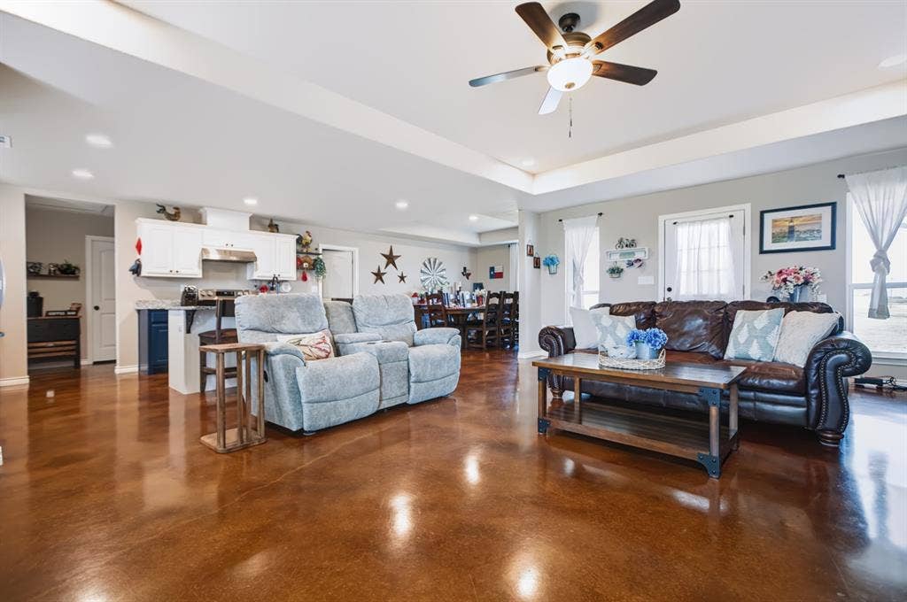 2433 Trlica Road, West, TX 76691 Open-concept living area with tray ceiling, ceiling fan, and recessed lighting