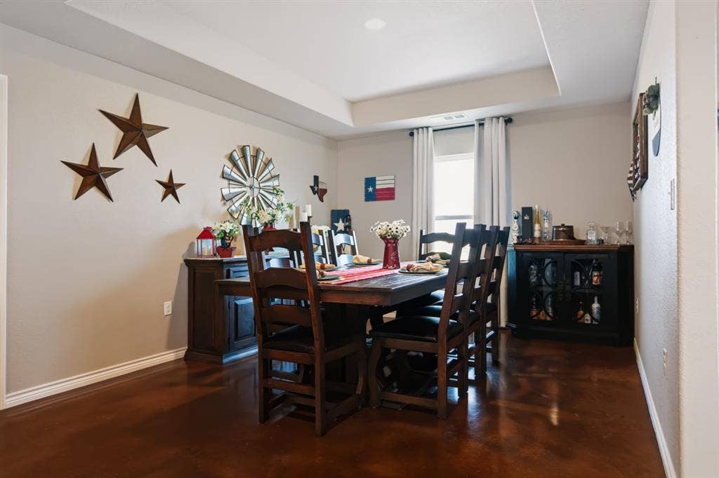 2433 Trlica Road, West, TX 76691 Recessed lighting, tray ceiling, neutral wall color, and dark-toned flooring