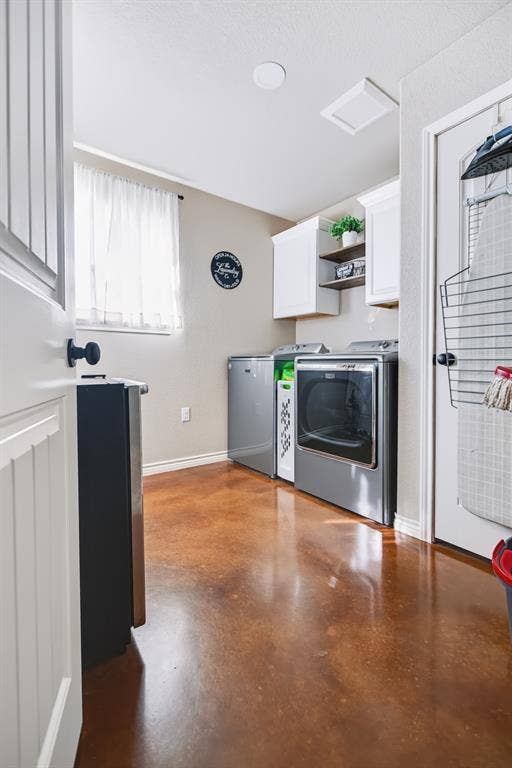 2433 Trlica Road, West, TX 76691 Laundry room featuring stained concrete flooring, white cabinetry, and a window for natural light