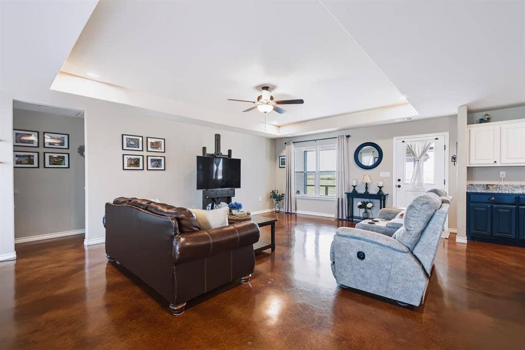 2433 Trlica Road, West, TX 76691 Expansive living area with high tray ceiling, wood-finish flooring, and recessed lighting