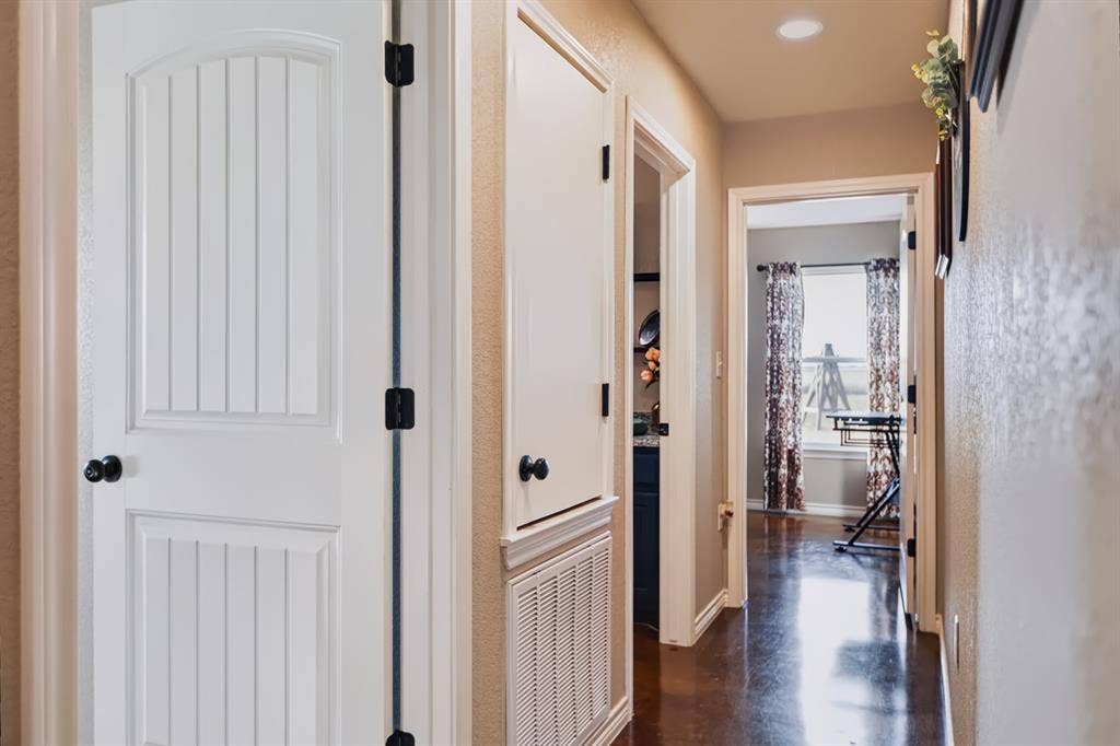 2433 Trlica Road, West, TX 76691 Hallway featuring recessed lighting, dark wood-finish flooring, and white paneled doors with dark hardware