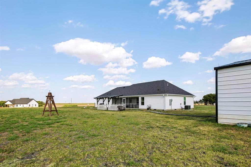 2433 Trlica Road, West, TX 76691 White siding residence with a dark shingle roof and a screened porch