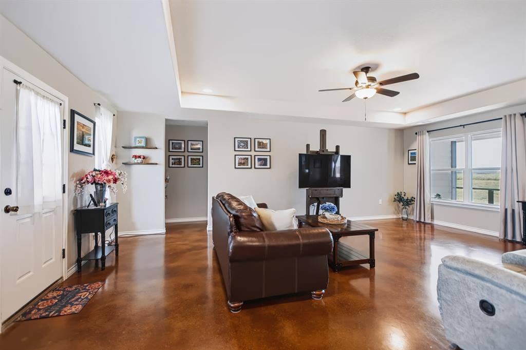 2433 Trlica Road, West, TX 76691 Tray ceiling with recessed lighting, ceiling fan, wood-finish flooring, white trim, and a window with a white sill