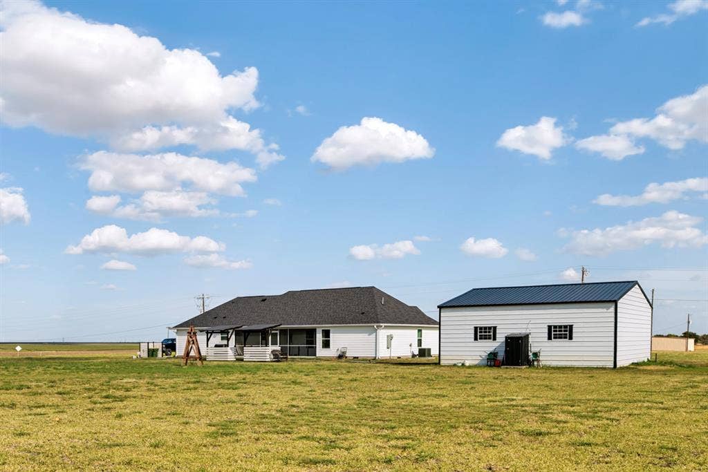 2433 Trlica Road, West, TX 76691 Single-story residence with a covered patio and an auxiliary structure featuring a metal roof