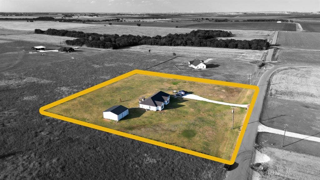 2433 Trlica Road, West, TX 76691 Expansive rural property featuring a main residence, detached outbuilding, and a long driveway