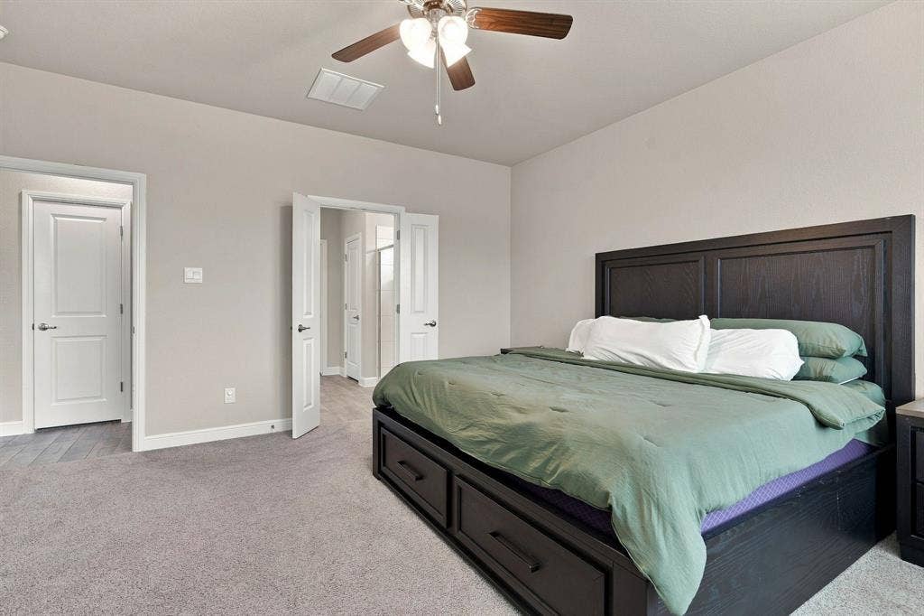 Recessed lighting, wood-finish ceiling fan, and light gray wall paint