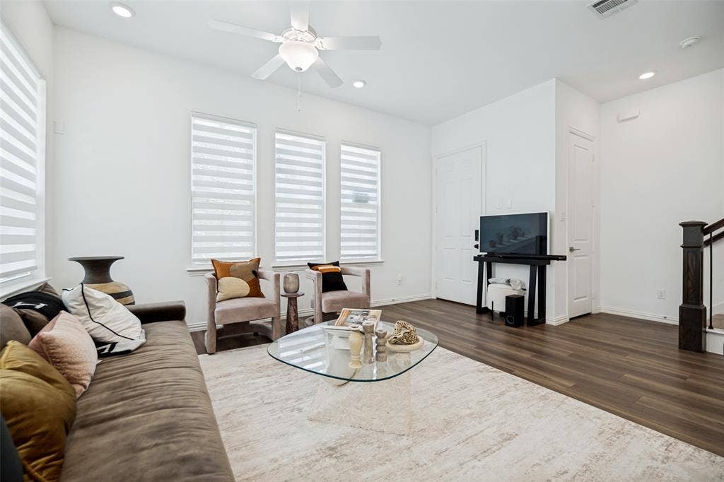 7536 Laburnam Road, Dallas, TX 75228 Recessed lighting, ceiling fan, wood-finish flooring, white walls, and dark wood staircase with iron balusters