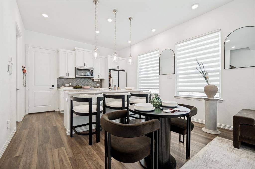 7536 Laburnam Road, Dallas, TX 75228 Kitchen featuring white cabinetry, a kitchen island with a light-toned countertop, and recessed ceiling lighting