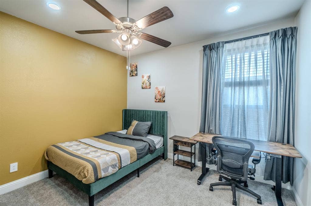 Recessed lighting, ceiling fan with light fixture, carpeted flooring, window with blinds and curtains, and a two-tone wall finish