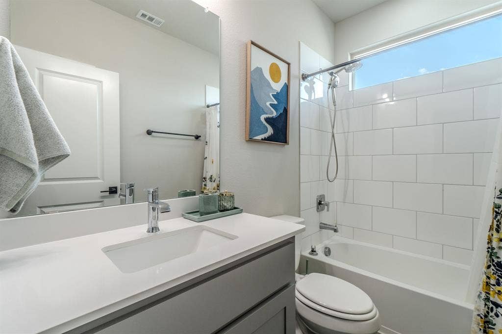 Integrated vanity with a rectangular basin, chrome faucet, and expansive mirror