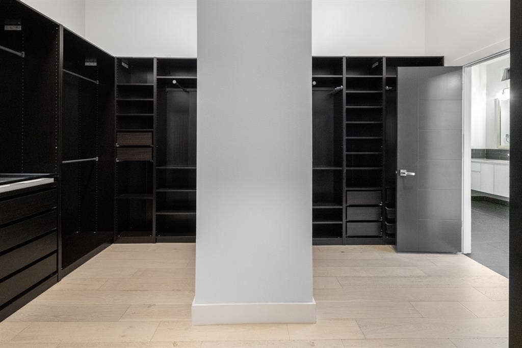 1321 Black Walnut Lane, Arlington, TX 76005 Custom closet system featuring dark wood-finish cabinetry, integrated shelving, and drawer storage