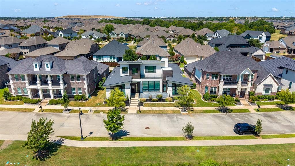 1321 Black Walnut Lane, Arlington, TX 76005 Striking contemporary residence showcasing a symmetrical facade with mixed exterior materials including brick and stone accents, expansive glass panels, and a flat roofline