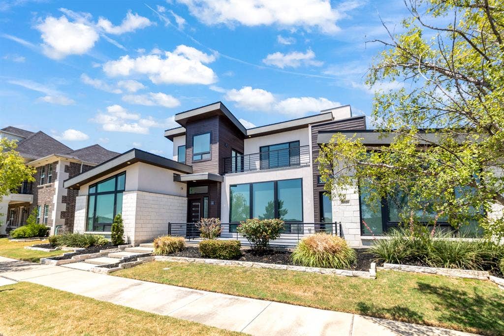 1321 Black Walnut Lane, Arlington, TX 76005 Modern two-story residence featuring a mixed-material exterior with dark metal accents, expansive multi-pane windows, and a clean horizontal roofline