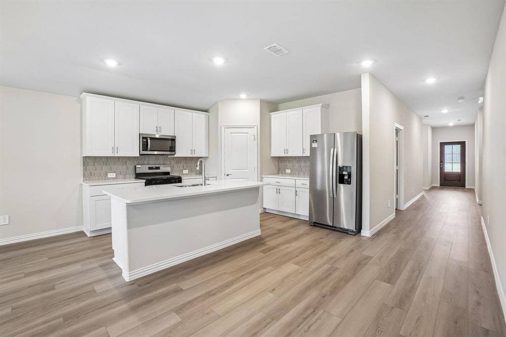 2138 Longchamp Lane, Seagoville, TX 75159 Photo is not of the actual home, but is an inspirational photo of builder’s model home and may depict options, furnishings, and/or decorator features that are not included.