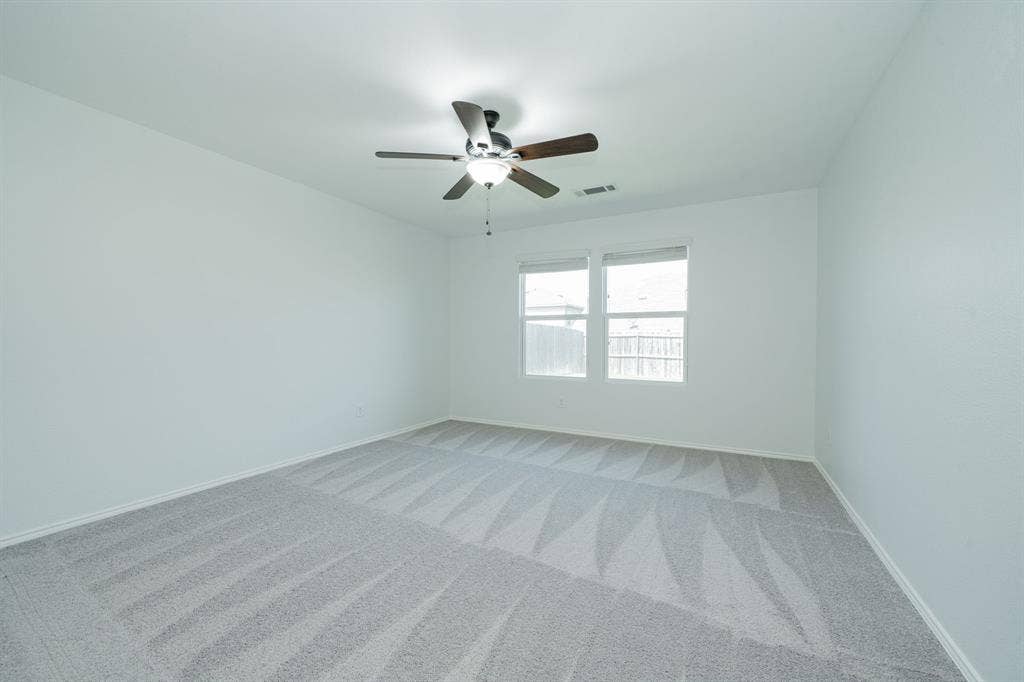 122 Feverbush Drive, Fate, TX 75189 Spare room featuring light colored carpet and ceiling fan