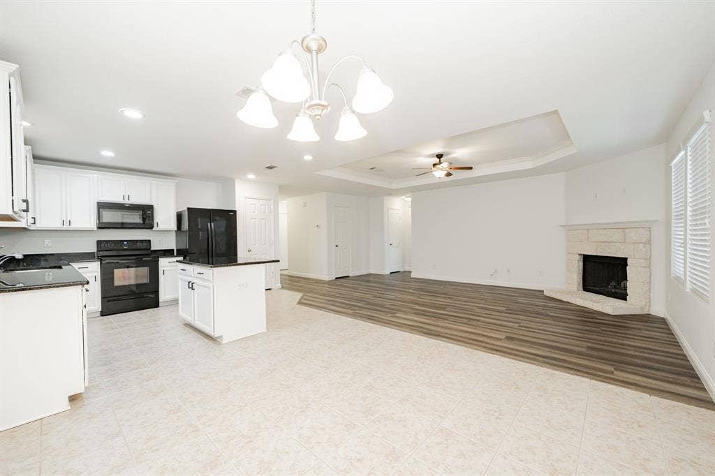 122 Feverbush Drive, Fate, TX 75189 Kitchen with black appliances, dark countertops, ceiling fan, a chandelier, and crown molding