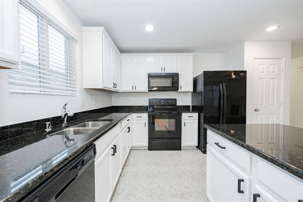 122 Feverbush Drive, Fate, TX 75189 Kitchen featuring black appliances, white cabinets, dark stone countertops, recessed lighting, and light tile patterned flooring