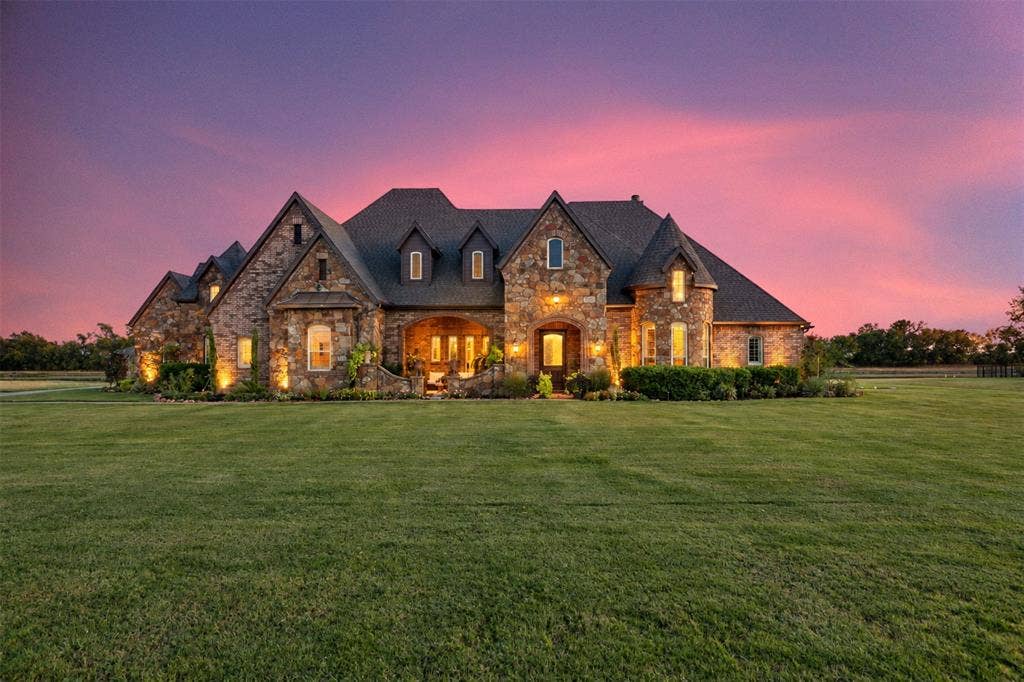 623 Calm Water Cove, Princeton, TX 75407 Stone-clad exterior with multiple gables, dormer windows, a covered entry, and extensive lawn space