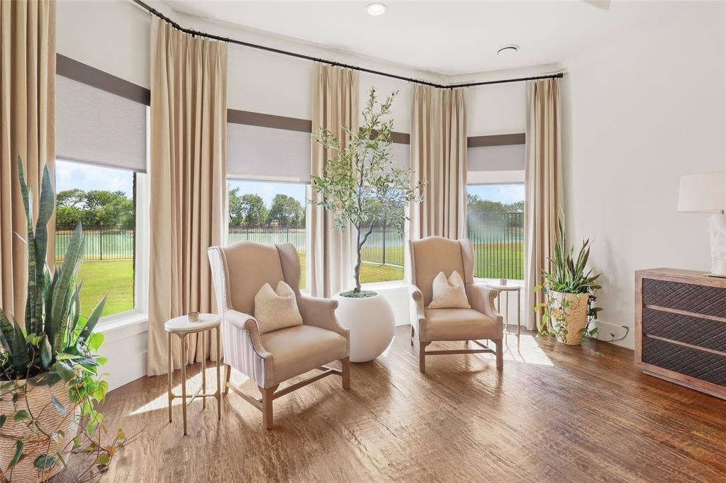 623 Calm Water Cove, Princeton, TX 75407 Bay window with roller shades, hardwood-finish flooring, and light-toned curtains