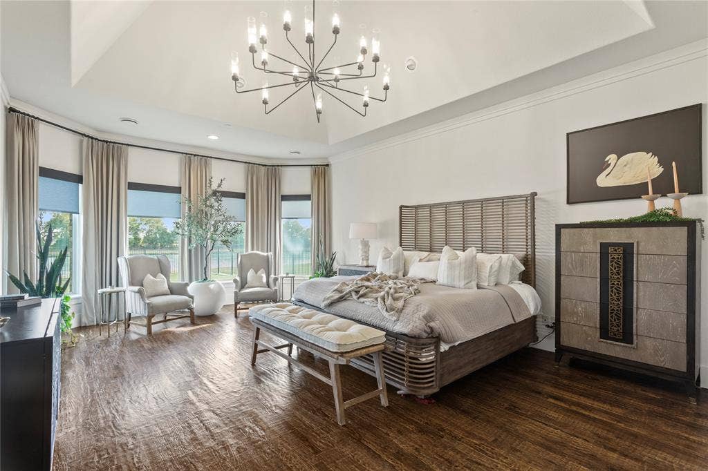 623 Calm Water Cove, Princeton, TX 75407 Tray ceiling, dark wood-finish flooring, bay window with multiple panes, contemporary chandelier, and recessed lighting