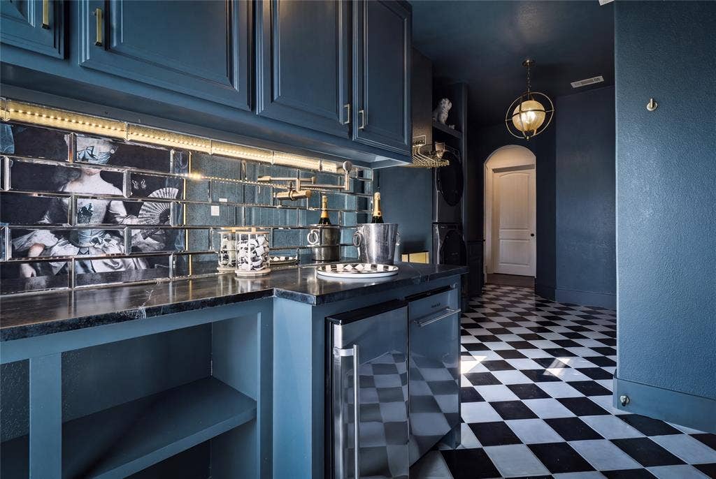 623 Calm Water Cove, Princeton, TX 75407 Built-in cabinetry with dark finish, under-cabinet lighting, patterned backsplash, integrated beverage refrigerator, and black and white checkered flooring