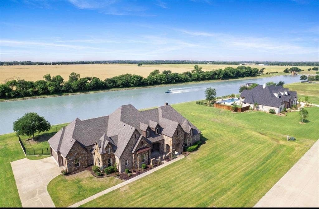 623 Calm Water Cove, Princeton, TX 75407 Stone veneer exterior with multiple gables and a dark shingle roof