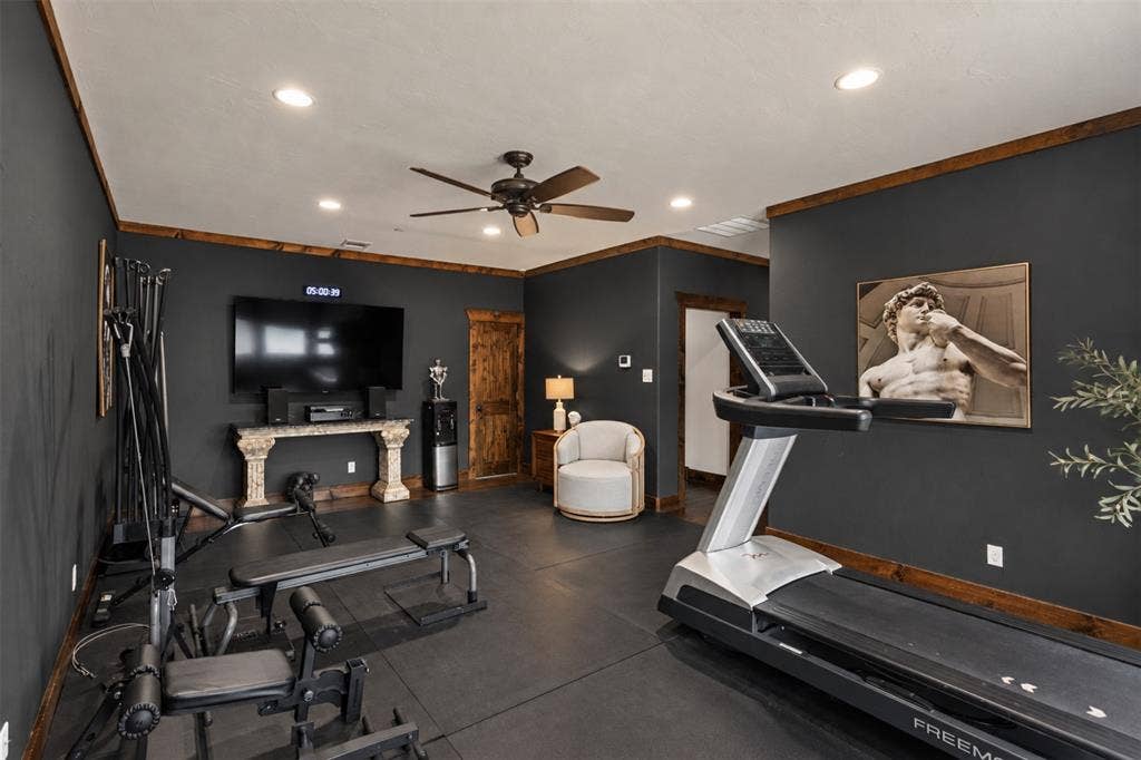 623 Calm Water Cove, Princeton, TX 75407 Recessed lighting, ceiling fan, dark-toned walls, and wood-trim accents