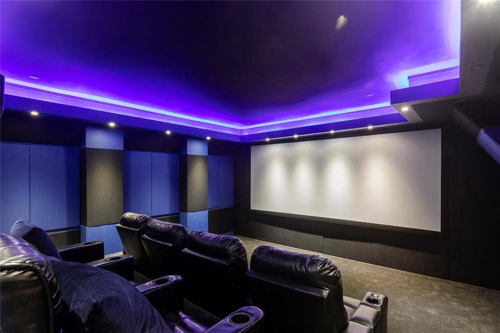 623 Calm Water Cove, Princeton, TX 75407 Custom home theater with recessed lighting, ambient cove lighting, large projection screen, and sound-absorbing wall panels