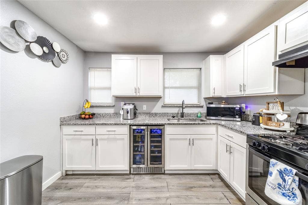 726 Royal Crest, Mesquite, TX 75149 Kitchen featuring stainless steel appliances, beverage cooler, white cabinets, and recessed lighting