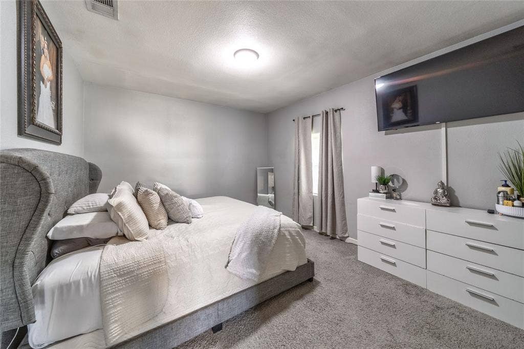 726 Royal Crest, Mesquite, TX 75149 Carpeted bedroom with a textured ceiling